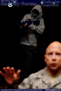 Tech. Sgt. Ajenna Smith, 422nd Security Forces Squadron noncommissioned officer in charge of training and simulated-active shooter, opens fire on a crowd during a commander’s call at RAF Croughton, United Kingdom, July 22, 2014. Smith said her goal during this training exercise was to kill as many people as possible in a short amount of time. (U.S. Air Force photo by Staff Sgt. Jarad A. Denton/Released)